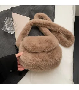 Detail of soft brown faux fur crossbody bag featuring a plush wide shoulder strap and flap closure