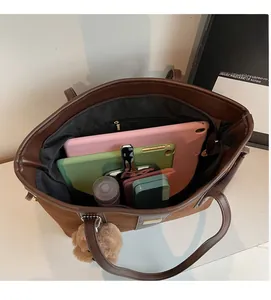 Interior view of brown suede tote bag showing large capacity for tablet and items