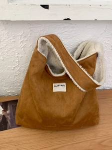 Brown faux suede tote bag with white faux fur lining and OUR FAVE logo for autumn winter