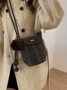 Vintage bucket bag in dark grey with contrast stitching and fuzzy ball pendant decor
