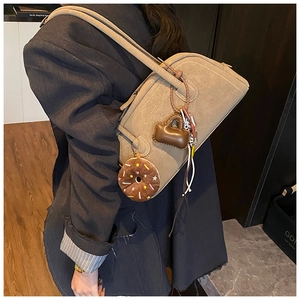 Detail of khaki frosted leather shoulder bag with vintage donut and mini bag charms