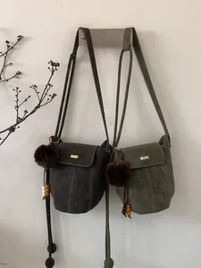 Retro faux suede bucket crossbody bags in coffee and olive green with fur ball charms
