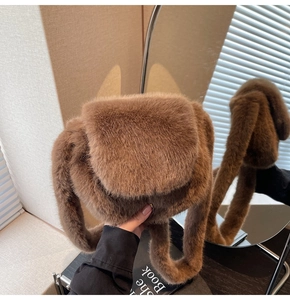 Detail of plush faux fur shoulder bag in brown with fluffy texture and thick strap