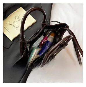 Deep brown leather handbag interior view showing storage space for cosmetics and essentials