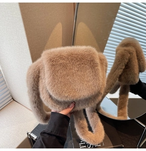 Close-up of fluffy khaki faux fur crossbody bag with matching plush shoulder strap