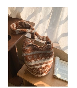 Gros plan du sac seau en peluche à motif géométrique sur une table en bois naturel