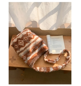 Détail d'un sac seau pelucheux avec motifs géométriques et texture polaire douce