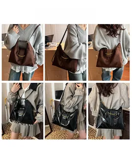Detail view of large tote bags in suede brown and glossy black with gold metal buckles