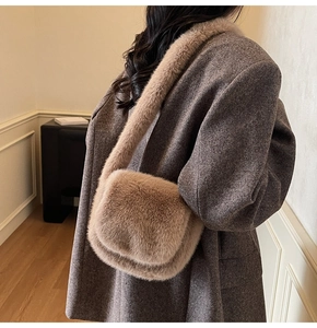 Detailed side view of a plush camel shoulder bag styled with a grey tweed coat