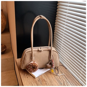 Close-up of beige vintage Boston bag with dual metal zippers and heart-shaped charms