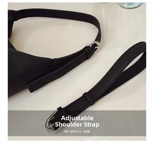 Detail showing adjustable black litchi leather strap with silver metal pin buckle