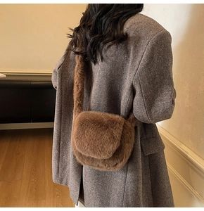 Close-up of fluffy brown faux fur crossbody bag with a wide plush strap for autumn style