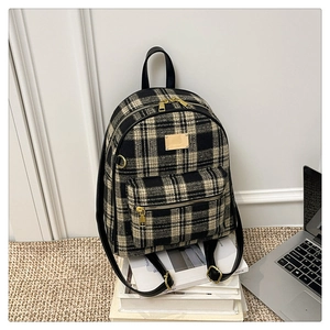 Détail du sac à dos vintage en tweed à carreaux avec des finitions dorées chic