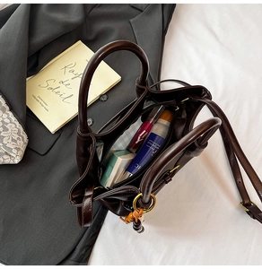 Macro view of large capacity dark brown tote bag with smooth texture and internal storage