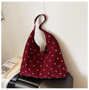 Detail of dark red suede hobo bag with silver rivets and large capacity for daily use