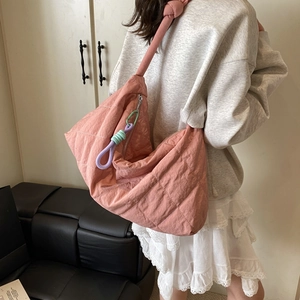 Quilted rose pink tote bag with stylish knotted shoulder strap and contrast knot charm