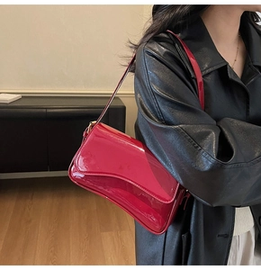 Fashionable red patent leather shoulder bag styled with a black leather jacket