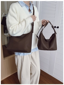Detailed comparison of two brown lychee leather tote bags with elegant metallic hardware