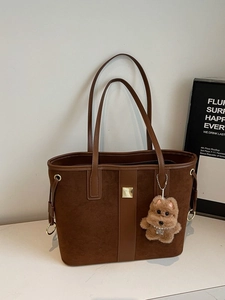Dark brown suede tote bag with leather strap and plush dog charm accessory