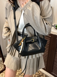 Fashionable black leather dumpling crossbody bag with stylish beaded charm accessory