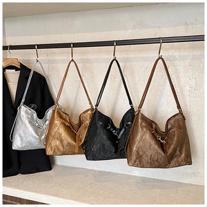 Detail view of large commuter tote bags in silver gold black and bronze metallic textures