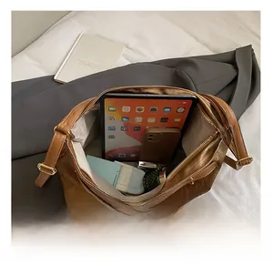 Detail view of brown textured leather tote showing large capacity and interior space