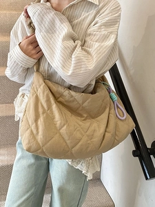 Chic khaki quilted crossbody bag with diamond stitch pattern and colorful knot charm