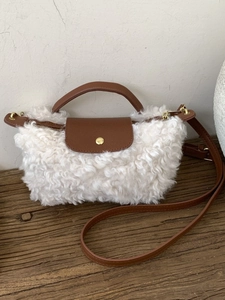 Winter lamb wool crossbody dumpling bag with brown leather strap and gold clasp