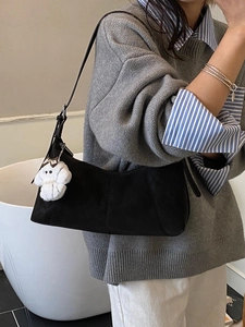 Minimalist black matte crossbody dumpling bag with cute white puppy pendant accessory