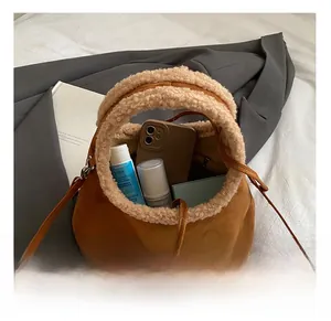 Brown suede bag with white fleece handle showing spacious interior and items