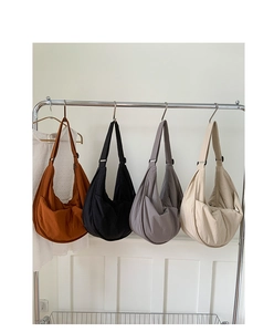 Detail showing high-capacity nylon crescent bags in brown black grey and beige colors