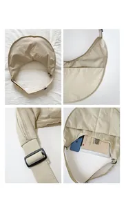 Macro details of beige nylon crescent bag showing strap buckle and large interior capacity