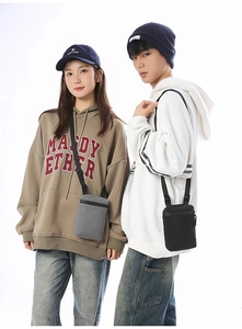 Models wearing gray and black waterproof nylon crossbody bags for daily essentials
