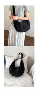 Detail of a black nylon crescent crossbody bag with an adjustable wide shoulder strap