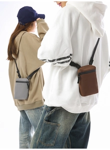 Close-up of lightweight nylon crossbody phone bag with waterproof zipper and adjustable strap