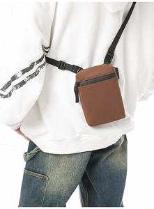 Brown nylon crossbody phone bag featuring waterproof zipper and adjustable strap