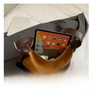Detailed interior view of tan pleated bag showing large capacity for tablet and daily items