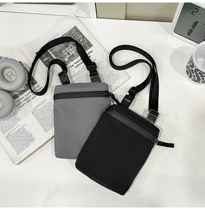 Minimalist nylon crossbody phone bags in black and grey with waterproof zippers