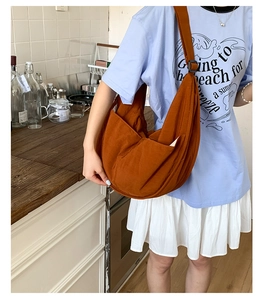 Detail of caramel nylon hobo bag featuring a large capacity half-moon shape and wide strap