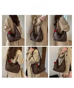Detailed look at vintage paisley and leopard print tote bags with fuzzy pompom charms
