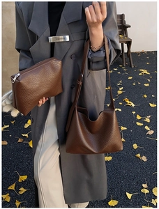 Close-up of brown litchi pattern leather shoulder bag and matching pouch set