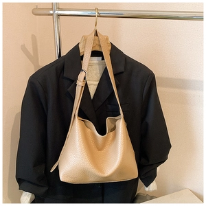 Detail of lychee pattern leather tote bag with adjustable strap and textured finish