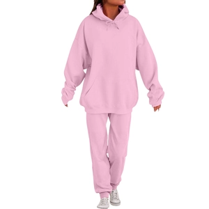 Detail view of light pink men's hooded tracksuit featuring kangaroo pocket and joggers