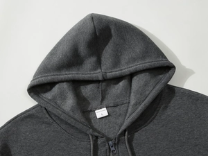 Detail of size L neck label and fleece texture on dark grey zip-up hoodie