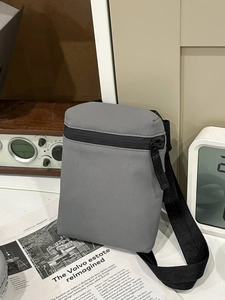 Minimalist grey crossbody bag with matte fabric and adjustable black shoulder strap