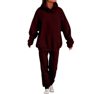 Detail view of burgundy men's tracksuit featuring a drawstring hoodie and matching joggers