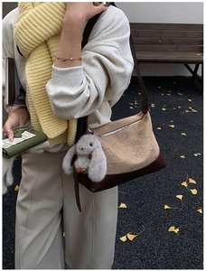 Hobo shoulder bag in beige suede and brown leather with cute bunny charm on model