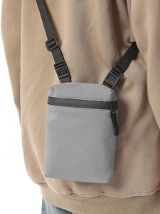 Minimalist grey water-resistant crossbody bag with adjustable wide straps and zip closure