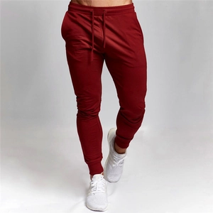 Detail view of burgundy slim fit joggers showing drawstring waist and ribbed cuffs