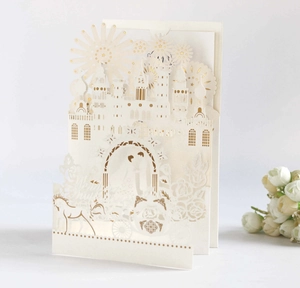 3D pop-up wedding invitation featuring a gold-stamped castle and horse carriage design
